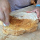 An olive tree slice, gets coated with Forberz Wood Finish quick and easy, no dripping, no chemical smell, just 100% natural honey extracts with no silicone or solvents to protect your wood pieces and give them the perfect look of wet fresh wood while leaving the treated surfaces smooth and dry to the touch